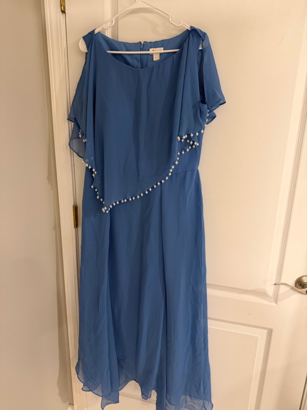 Blue shin length dress with pearl lined cape